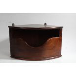 A 19th Century mahogany bow front corner candle box, with swept recessed compartment, 38cm wide,
