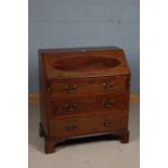 Edwardian mahogany and inlaid bureau, the sloping fall enclosing a pigeon hole interior, fitted