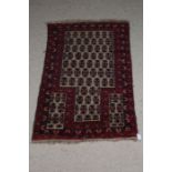Afghanistan style prayer rug, the red and cream ground decorated with guls and multiple borders with