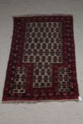 Afghanistan style prayer rug, the red and cream ground decorated with guls and multiple borders with