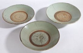 Three 18th/19th century Chinese provincial celadon wreck dishes, crazed & pitted, 24.5cm, 25.5cm and