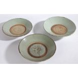 Three 18th/19th century Chinese provincial celadon wreck dishes, crazed & pitted, 24.5cm, 25.5cm and