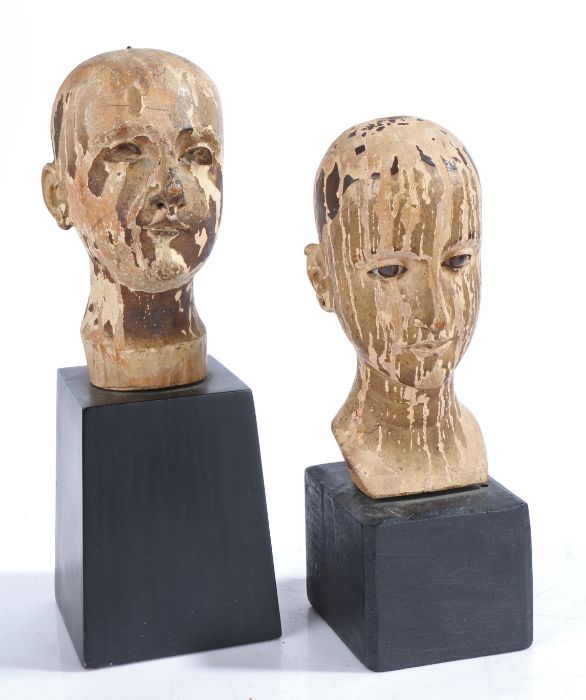 Two 19th Century carved heads, possible Lay figure heads/ doll heads, with flaked paint above