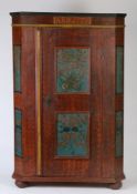 A 19th Century Swedish painted cabinet, in iron red swirls and blue scroll panels, the frieze with