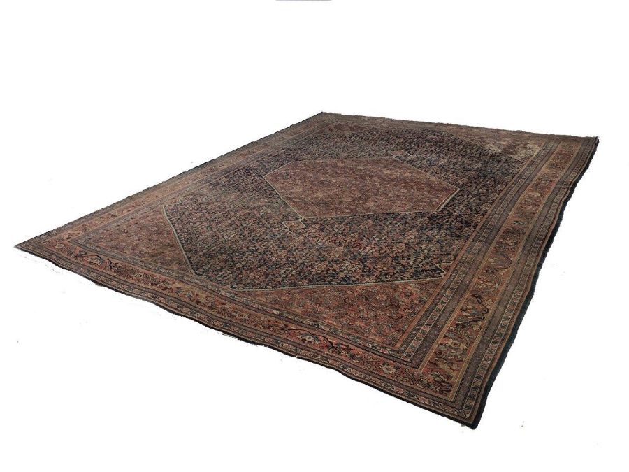 An Isphahan carpet, central terracotta medallion on blue field, terracotta spandrels, with all-