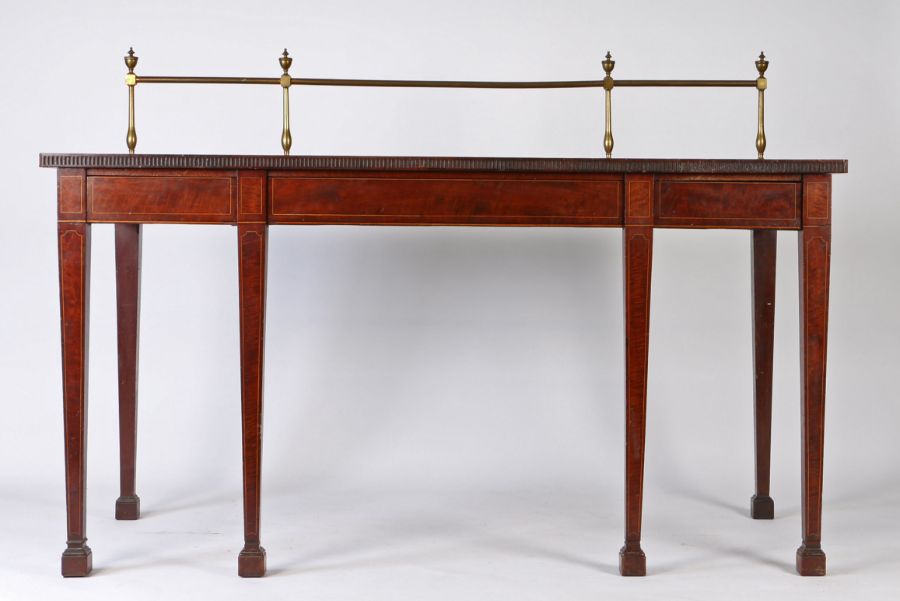 A Regency mahogany and boxwood strung serving table, the brass gallery back surmounted by urns above