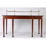 A Regency mahogany and boxwood strung serving table, the brass gallery back surmounted by urns above