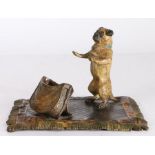 After Franz Bergmann (1861-1936) An Austrian cold painted bronze deskstand as begging dog on rug,