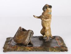 After Franz Bergmann (1861-1936) An Austrian cold painted bronze deskstand as begging dog on rug,