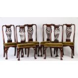 A set of six George III cherry wood dining chairs, the scroll undulating top rail above a wide