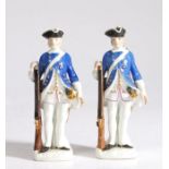 A pair of 19th Century Meissen porcelain figures, circa 1740, modelled as soldiers in blue coats and