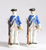 A pair of 19th Century Meissen porcelain figures, circa 1740, modelled as soldiers in blue coats and