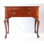 A George III mahogany lowboy, the rectangular top above two short and one long frieze drawer above
