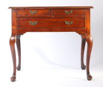 A George III mahogany lowboy, the rectangular top above two short and one long frieze drawer above