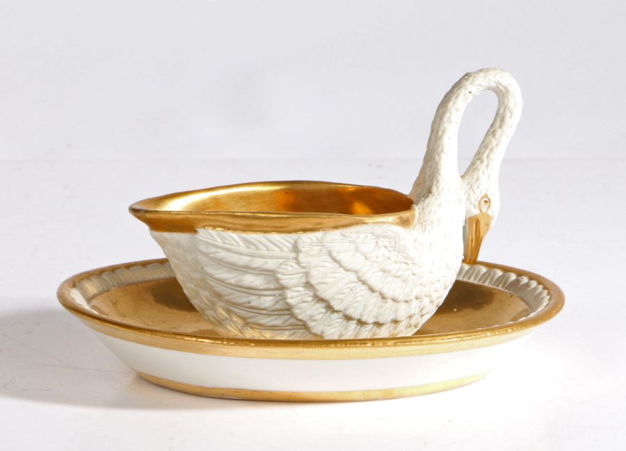 An early 19th Century Dagoty porcelain sauce boat and saucer, the sauce boat modelled as a swan with