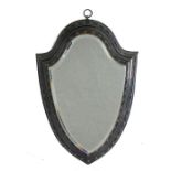 A mid 19th Century shield shape hanging wall mirror, the the shaped mirror plate with faceted edge