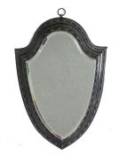 A mid 19th Century shield shape hanging wall mirror, the the shaped mirror plate with faceted edge