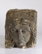 Post-medieval stone corbel, carved with a figure with flowing hair, 17.5cm wide, 18cm high, 17cm