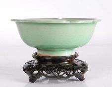 Chinese celadon bowl, the central field with stylised flower head decoration, raised on a pierced