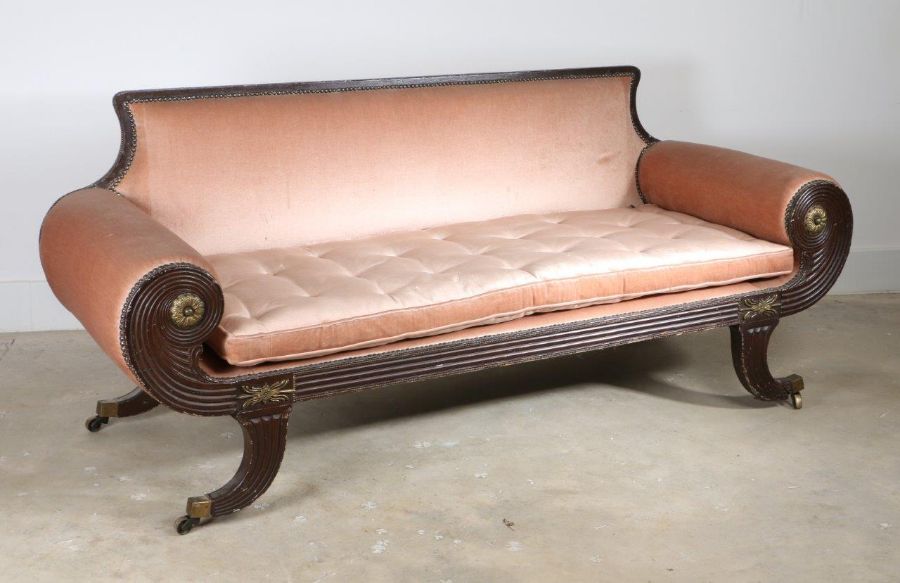 A Regency painted settee, the pad back and painted frame with scroll arms surmounted by gilt metal