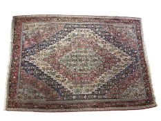 A fine Kilim rug, the central medallion on blue, red and ivory field, stylised floral motifs,