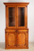 A Victorian Gothic-Revival satinwood bookcase, moulded cornice over twin glazed doors, three