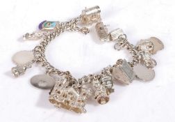 Silver and white metal charm bracelet, set with various charms to include boats, bike etc, weight