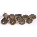 Nine Ecolab presentation badges set with mostly clear stones, stamped 1/10 10k, weight 40.7 grams