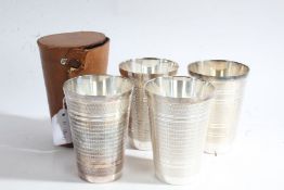 Set of four silver plated stirrup cups, of tapering form with engine turned exteriors, 11cm high,