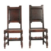A pair of early 18th century oak backstools, English, circa 1700-20 Each with a fielded back