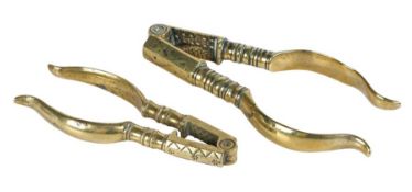 Two pairs of George III brass nutcrackers, circa 1790 Of lever-action form, each engraved, in the