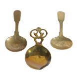 Three 19th century brass caddy spoons, English Two of similar design, engraved, and with fiddle-