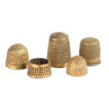 A group of five 14th -16th century latten thimbles, English All with small punched dots, one of open