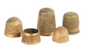 A group of five 14th -16th century latten thimbles, English All with small punched dots, one of open