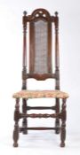 A William & Mary walnut and cane high-back chair, circa 1690 With simple scroll and pierced