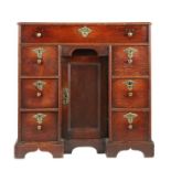 A particularly narrow and good George I oak kneehole desk, circa 1715-25 The one-piece boarded top