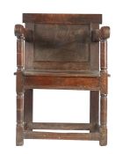 A Charles I joined oak panel-back open armchair, circa 1630 and later The back reduced in height,