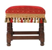 A Charles II oak and upholstered stool, circa 1660 The square stuff-over seat upholstered in crimson