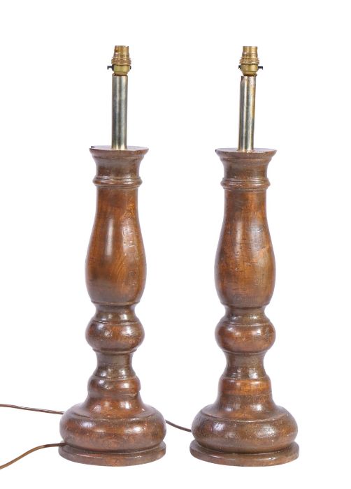 A pair of elm turned table lamps Each of balustroid design, with deep circular base, 66cm high, (