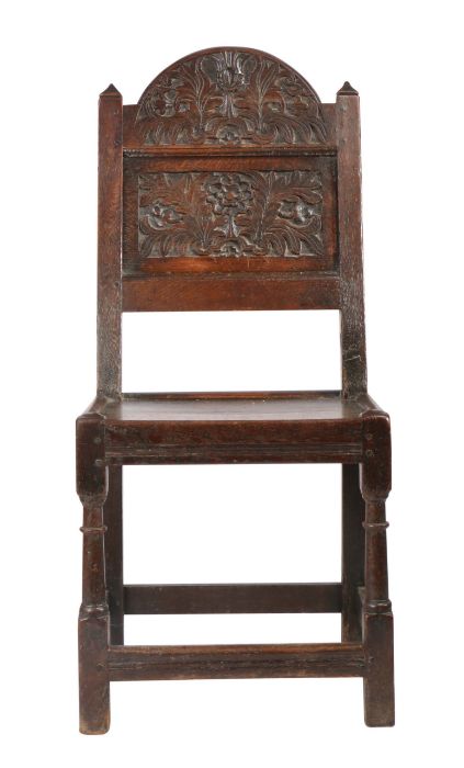 A Charles II oak backstool, Lancashire/Cheshire, circa 1680 Having an arched cresting and back panel