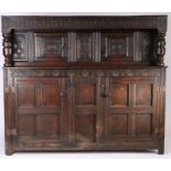 A large Charles II oak court cupboard, Dorset/Somerset, dated 1670 Having a fleur-de-lys lunette-