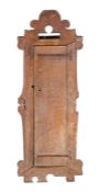An unusual chestnut upright cupboard, Spanish, circa 1700 Having a one-piece boarded door, within