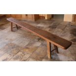 A Victorian pitch pine bench, circa 1840 Having a deep, one-piece rounded rectangular top, with