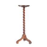 A late 17th century walnut candlestand, circa 1690 and later Having a circular dished top, on a