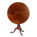 A George II 'red walnut' tilt-top tripod table, circa 1750 The large circular top formed from two