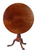 A George II 'red walnut' tilt-top tripod table, circa 1750 The large circular top formed from two