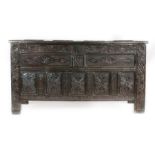 A Charles II joined oak coffer, Cumbria Having a quadruple-panelled hinged lid, the front with a