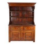 A George II small oak high dresser, circa 1750 The boarded canopy-type rack with pendant ended