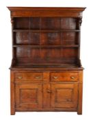 A George II small oak high dresser, circa 1750 The boarded canopy-type rack with pendant ended