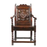 A Charles II oak panel-back open armchair, South Yorkshire, circa 1670 The uprights with inward